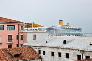 uma vista aérea do navio turístico e telhados da cidade de veneza, na itália.