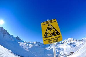 placa de sinal em altas montanhas sob neve no inverno foto