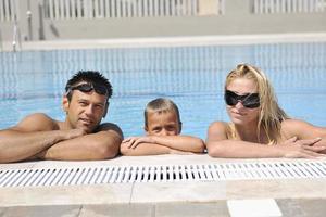 feliz jovem família se divertir na piscina foto