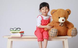 menina pré-escolar aprende na escola. menina se divertindo dentro de casa em casa, jardim de infância ou creche. foto