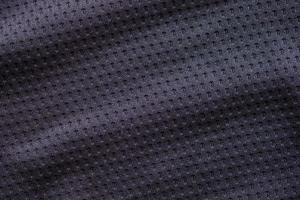 camisa de futebol de roupas esportivas de tecido preto com fundo de textura de malha de ar foto