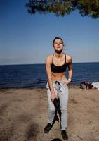 jovem fitness caminha no parque e posando para a câmera foto