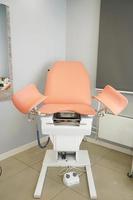 uma cadeira ginecológica em pé no centro da sala na clínica. gravidez. Medicina preventiva foto
