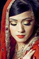 garota indiana em maquiagem de noiva lindamente feita foto