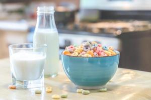 tigela de cereal infantil colorido e leite isolado na mesa de madeira com espaço de texto