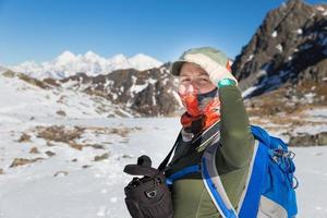 turista jovem mochileiro em pé montanhas de neve cume por