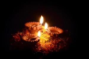 lâmpadas de argila diya acesas durante a celebração do diwali. cartão de boas vindas. foto