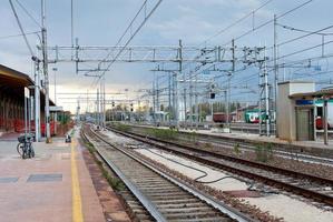 o último trem na estação ferroviária à noite foto