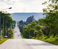 cenário. a estrada pavimentada com uma inclinação na colina. cercado por floresta verde ensolarado ao ar livre cópia espaço, conceito, viagens com conservação ambiental. foto