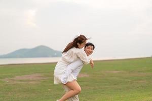 feliz jovem casal asiático em roupas de noivos foto