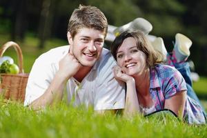 casal jovem feliz fazendo um piquenique ao ar livre foto