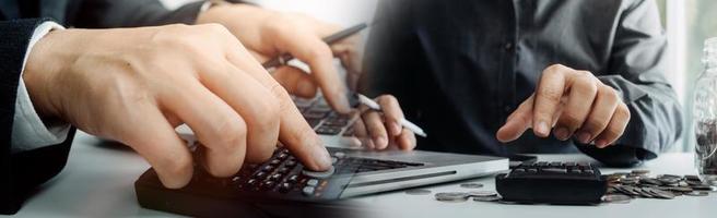 conceito de contabilidade empresarial, homem de negócios usando calculadora com computador portátil, orçamento e papel de empréstimo no escritório. foto
