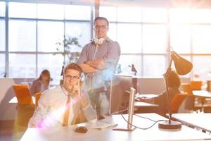 jovem empresário ajudando seu colega no trabalho foto