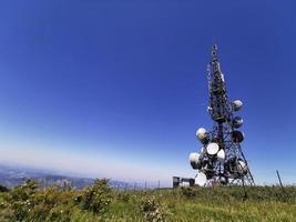 torre de antena de comunicação celular em fundo azul foto