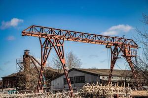 velho guindaste de pórtico enferrujado no canteiro de obras abandonado. foto