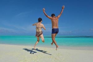 casal jovem feliz curtindo o verão na praia foto