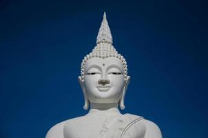 grande escultura de Buda branco no céu azul.