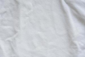 fundo de textura de jersey de roupas esportivas de tecido branco foto