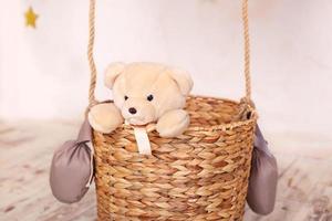 ursinho de pelúcia brinquedo sentado na cesta de balão foto