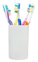 cinco escovas de dentes e escova interdental foto