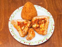 arancini de bolas de arroz recheadas de carne na mesa foto