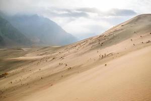 dunas de areia do deserto frio entre montanhas foto