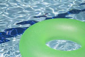 floatie inflável verde na piscina foto