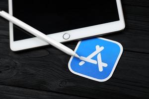 kharkiv, ucrânia - 27 de janeiro de 2021 novo apple ipad e lápis de maçã e logotipo azul da loja de aplicativos em fundo preto. maçã Inc. é uma empresa americana de tecnologia foto