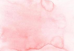 textura de fundo de cor rosa pastel aquarela. manchas em papel, pintadas à mão. foto