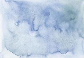 textura de fundo azul-cinza pastel aquarela. manchas em papel, pintadas à mão. foto