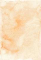textura de fundo de cor de pêssego pastel aquarela. pano de fundo aquarela. manchas alaranjadas claras no papel, pintadas à mão. foto