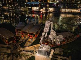 fenghuang, hunan.china-16 de outubro de 2018. pule a estátua do homem da água na cidade velha de fenghuang. cidade antiga de phoenix ou condado de fenghuang é um condado da província de hunan, china foto