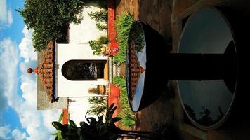 fonte de pedra, na antiga casa mexicana, américa latina, com azulejos decorados, telhas, vegetação circundante foto