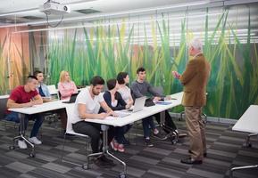 professor com um grupo de alunos em sala de aula foto