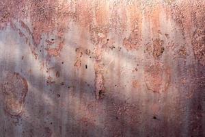 fundo de textura de concreto rachado rosa. foto