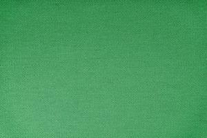 textura do padrão de tecelagem diagonal de tecido verde. fundo têxtil decorativo foto