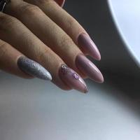 mulher com manicure cor de carne com design, close-up foto