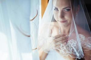 noiva linda se preparando no vestido de casamento branco com penteado