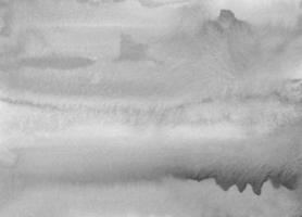 manchas de aquarela cinza na textura de fundo de papel. sobreposição de pano de fundo cinza monocromático. pintura moderna a preto e branco abstrata do aquarelle. foto