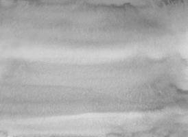 manchas cinzentas neutras em aquarela na textura de fundo de papel. sobreposição de pano de fundo monocromático. pintura moderna a preto e branco abstrata do aquarelle. foto