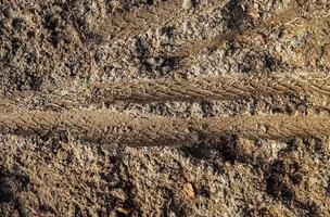 vista detalhada de perto em uma textura de terra de areia marrom foto