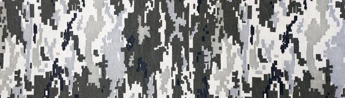 tecido com textura de camuflagem pixelizada militar ucraniana. pano com padrão de camuflagem em formas de pixel cinza, marrom e verde. uniforme oficial de soldados ucranianos foto