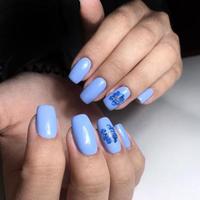 manicure feminina azul nas unhas close-up foto