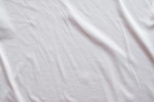 tecido branco roupas esportivas camisa de futebol com fundo de textura de malha de ar foto