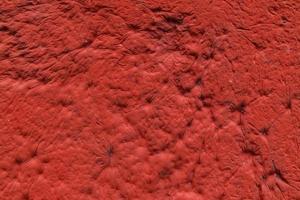 gesso vermelho com textura de parede de acabamento de recuo decorativo e fundo foto