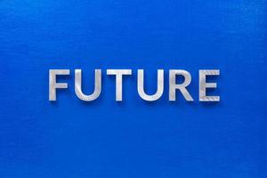 a palavra futuro colocada com caracteres de metal prateado no quadro azul em composição centrada plana leiga foto