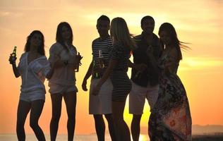 grupo de jovens aproveita a festa de verão na praia foto