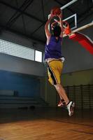 jogador de jogo de bola de basquete no pavilhão desportivo foto