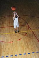 jogador de jogo de bola de basquete no pavilhão desportivo foto