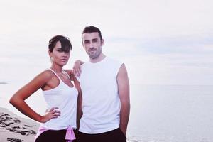 feliz casal jovem se diverte na bela praia foto